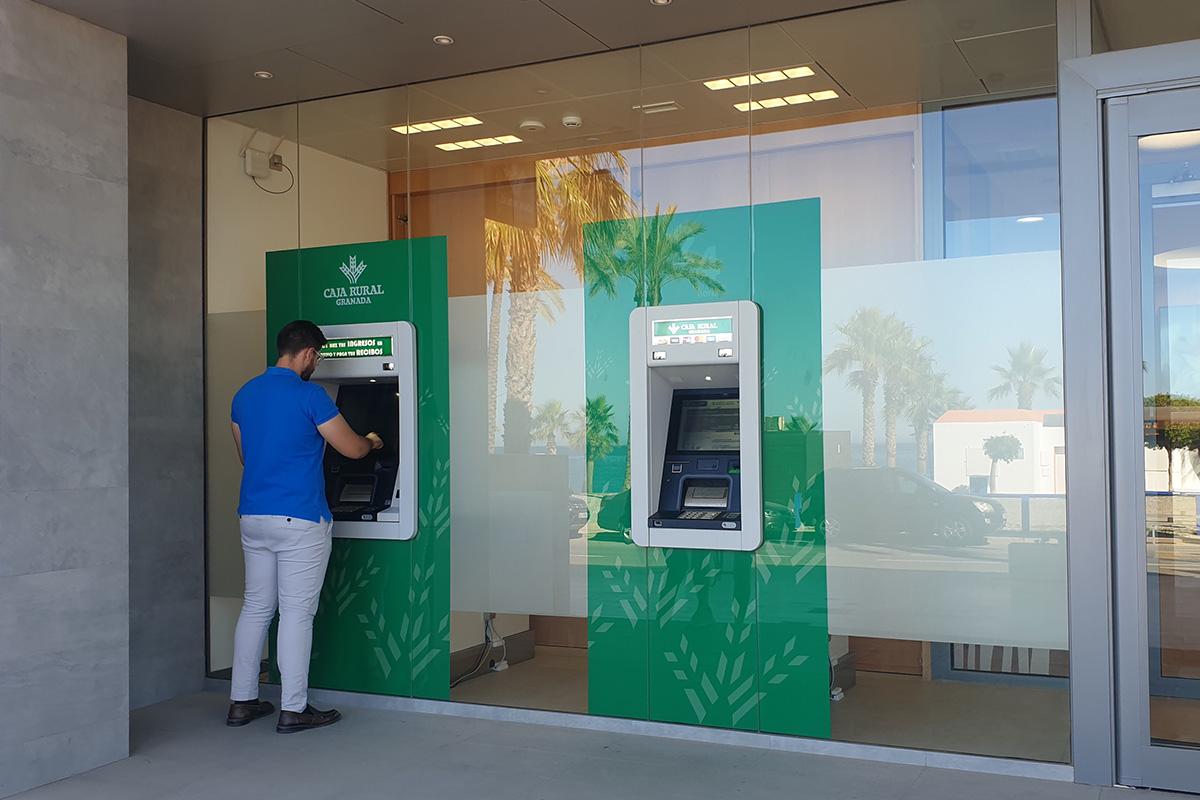 Hombre sacando dinero de la Nueva red de cajeros de Caja Rural Granada